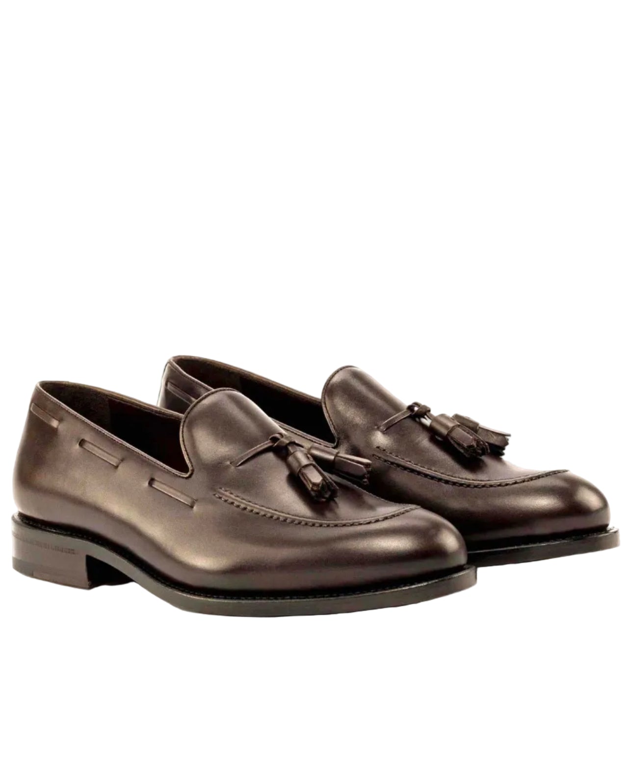 Pair of brown leather loafers with tassels on a white background