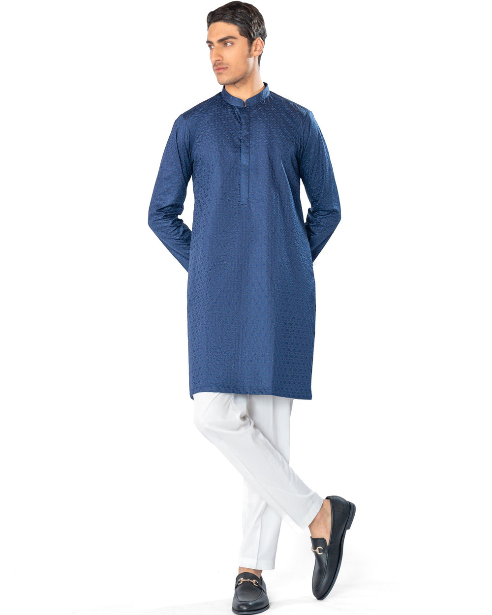 Man wearing a blue kurta with white pants on a white background