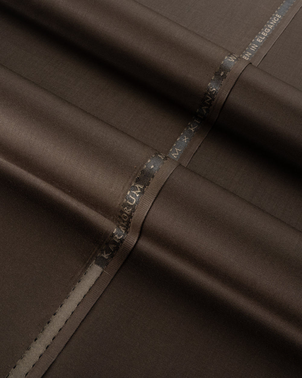 Close-up of brown fabric with a visible brand label.