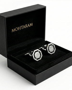 Silver cufflinks in a black 'Mohtaram' box on a white background