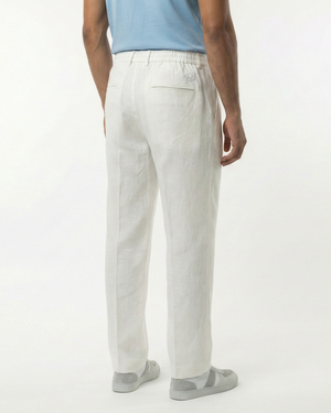 Person wearing light gray pants on a white background