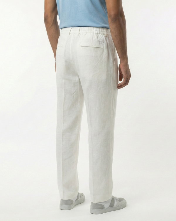 Person wearing light gray pants on a white background