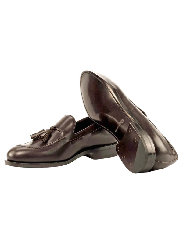 Pair of brown leather loafers on a white background