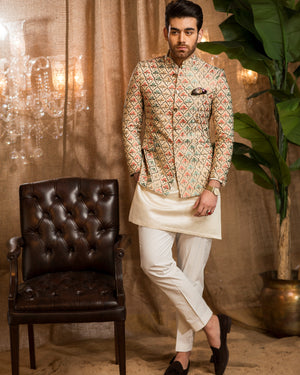 Man in traditional attire standing next to a brown leather chair with decorative elements.