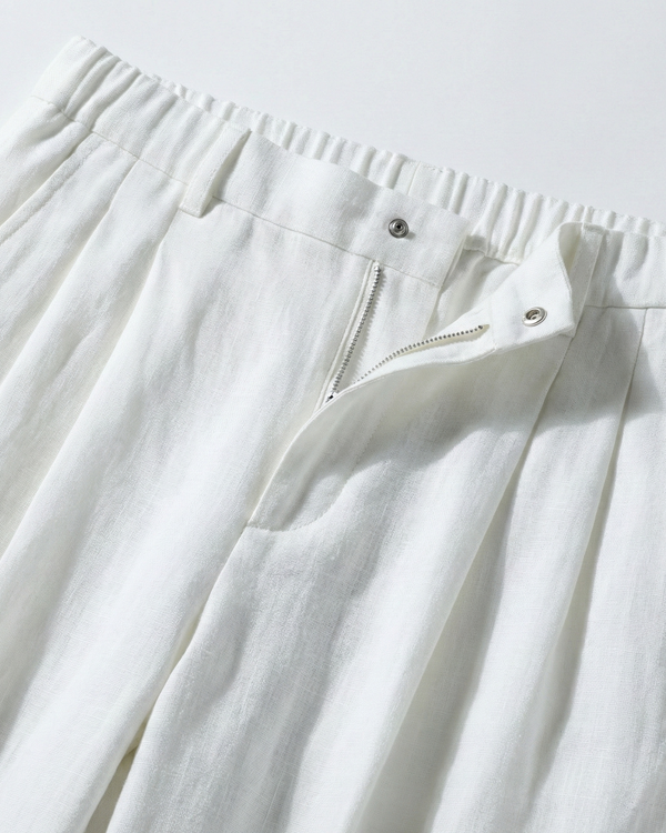 White pants with a zipper detail on a light gray background