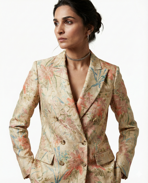 Woman wearing a floral blazer on a white background
