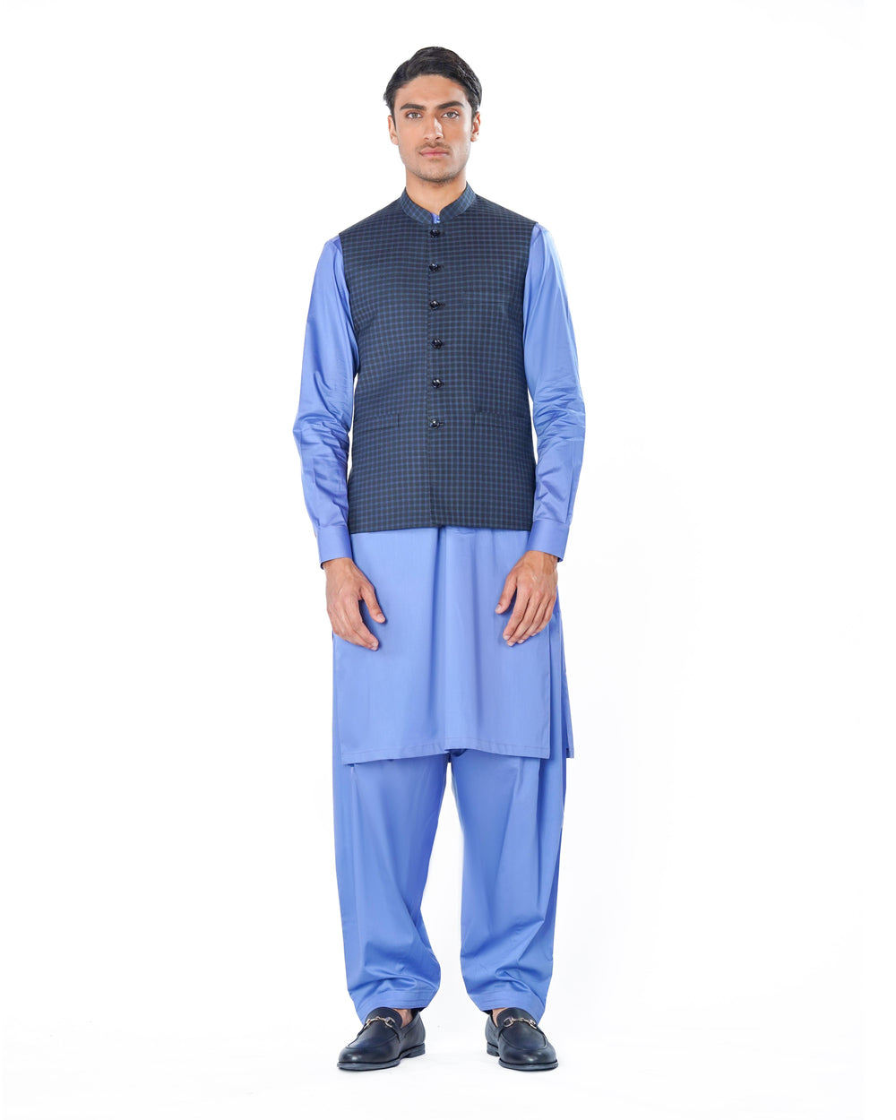Man wearing a blue kurta with a dark vest on a white background