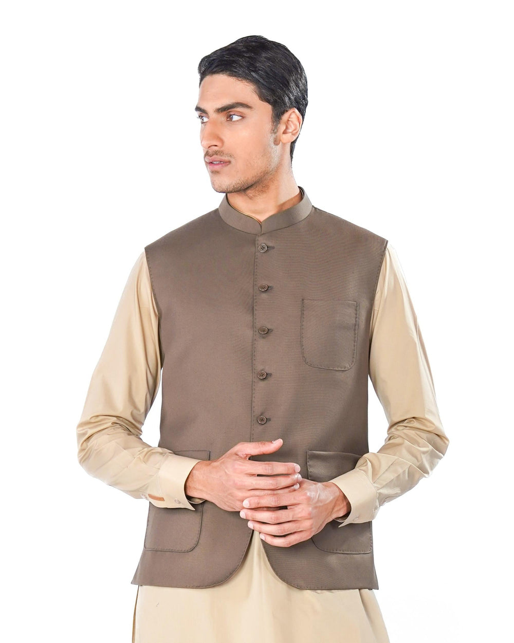 Man wearing a traditional outfit with a brown vest on a white background