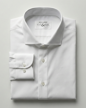 White dress shirt with folded cuffs on a light gray background