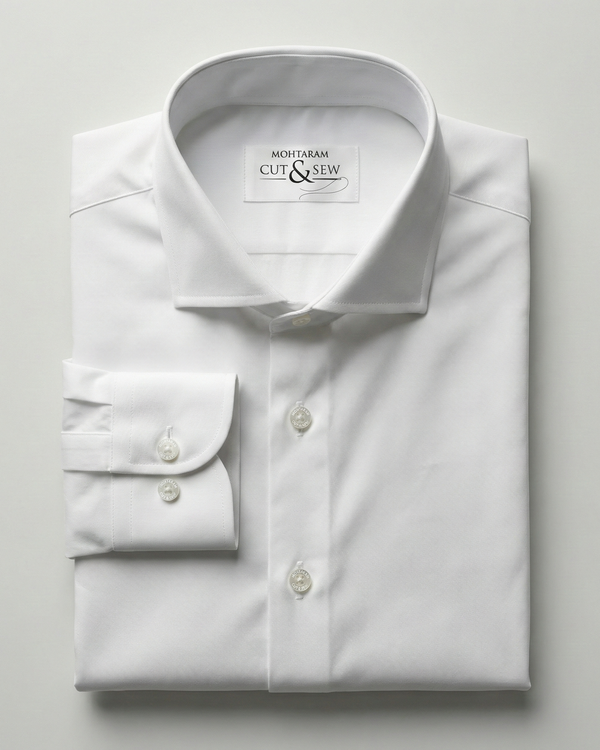 White dress shirt with folded cuffs on a light gray background