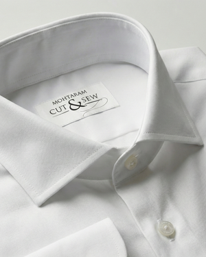 White dress shirt with a visible brand label on a light gray background