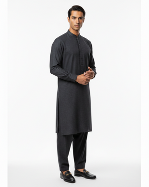Man wearing a black kurta with pants on a white background