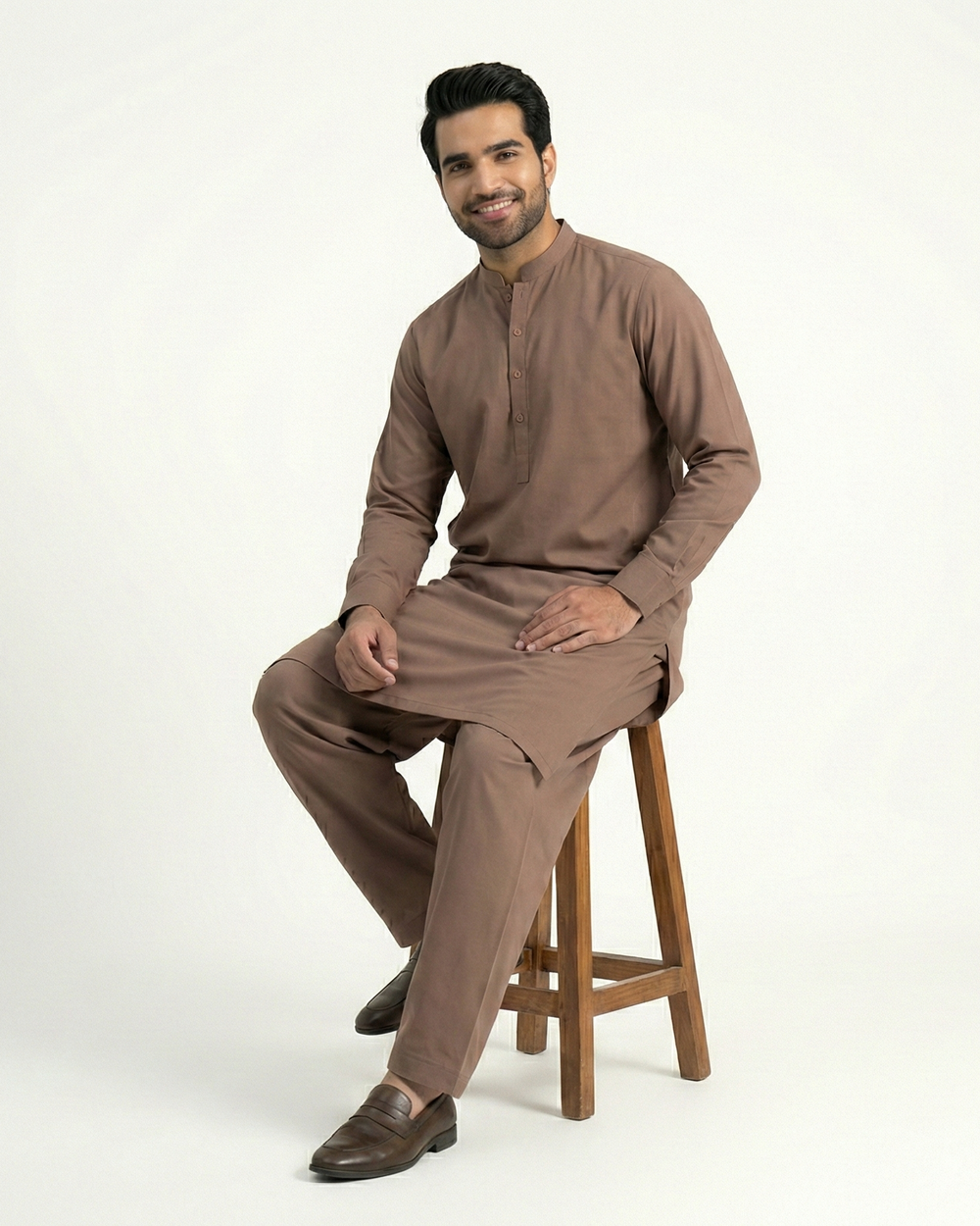 Man wearing a brown kurta with pants on a white background