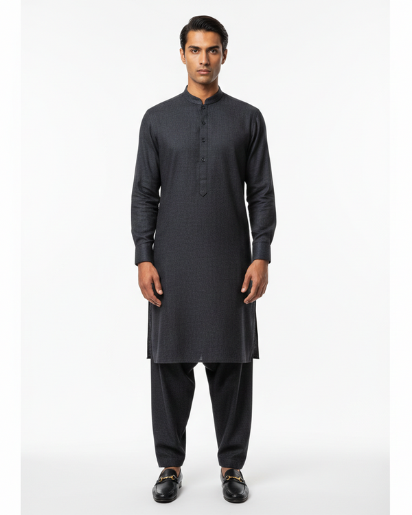 Man wearing a black kurta with pants on a white background