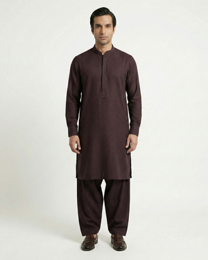 Man wearing a brown kurta with pants on a white background