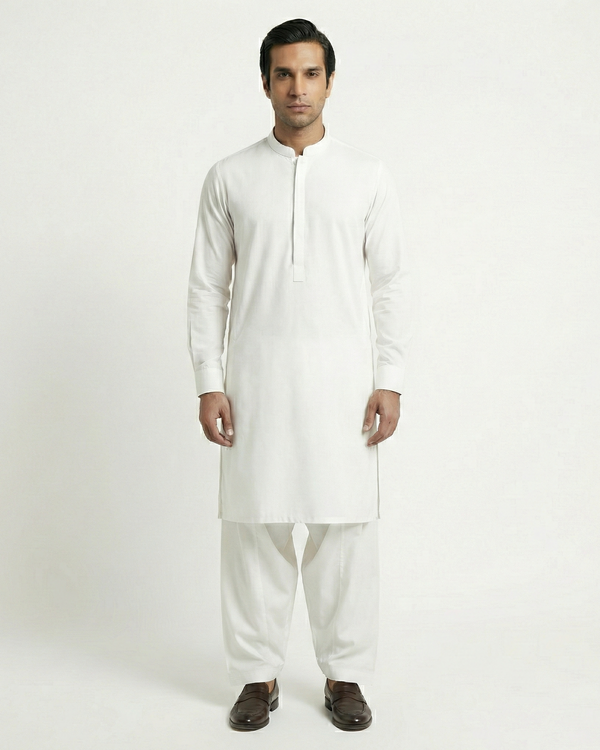 Man wearing a white kurta with pants on a white background
