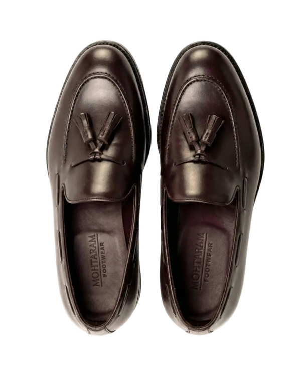 Pair of brown loafers with tassels on a white background, branded 'Montaram Footwear'.