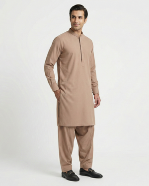 Man wearing a beige kurta with pants on a white background