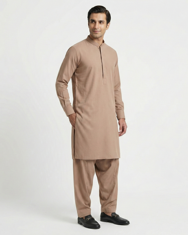 Man wearing a beige kurta with pants on a white background