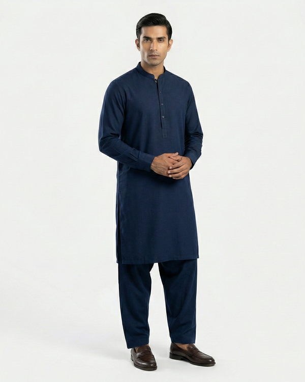 Man wearing a navy kurta with pants on a white background