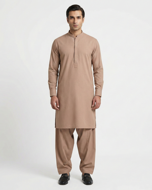 Man wearing a beige kurta with pants on a white background