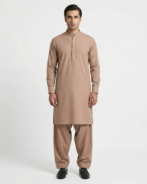 Man wearing a beige kurta with pants on a white background
