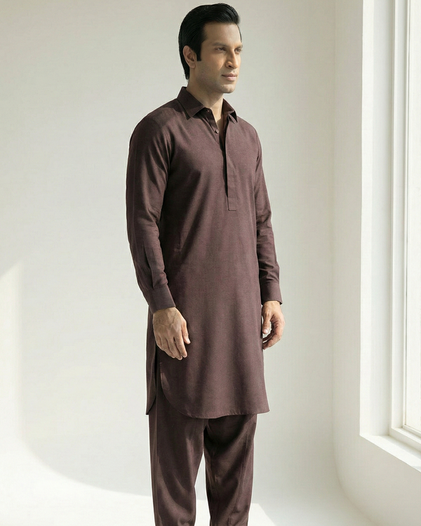 Man wearing a brown kurta with pants in a minimalistic setting