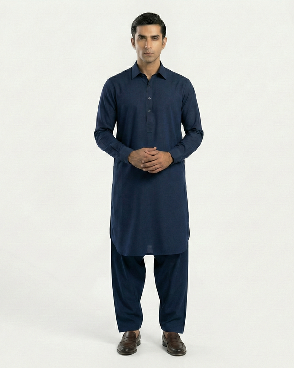 Man wearing a navy blue kurta with pants on a white background