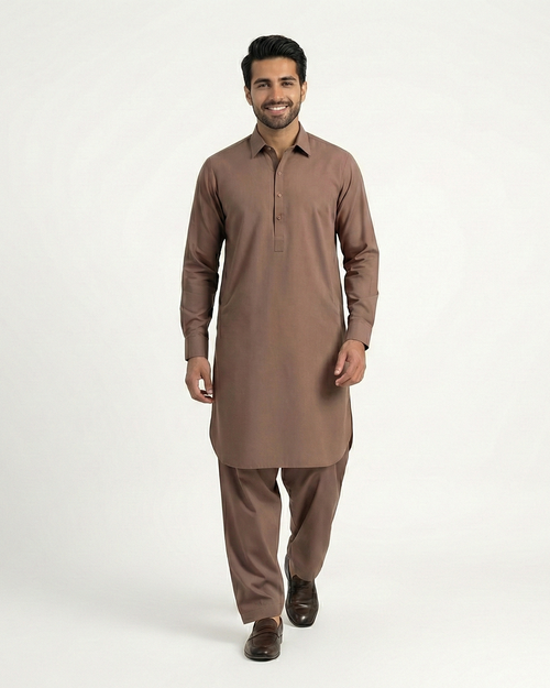Man wearing a brown kurta with pants on a white background