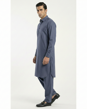 Man wearing a blue kurta with pants on a white background