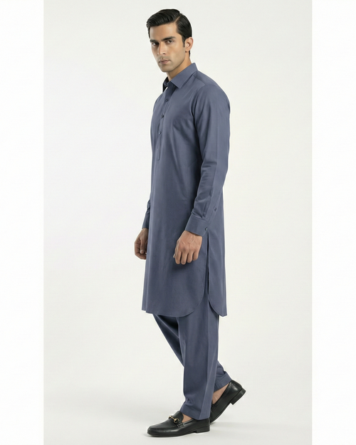Man wearing a blue kurta with pants on a white background