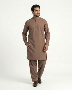 Man wearing a brown kurta with pants on a white background