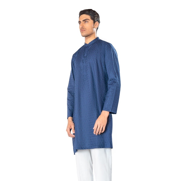 Man wearing a blue kurta with white pants on a white background