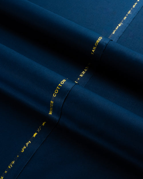 Navy fabric with gold thread and text, close-up view