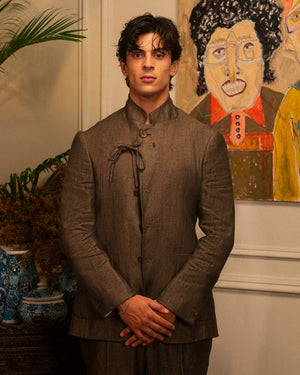 Mohtaram – Convertible jacket buttoned to a mandarin collar with a cord tie, front view
