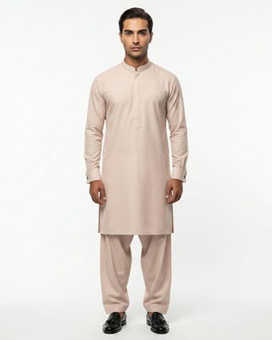 Man wearing a beige kurta set on a white background