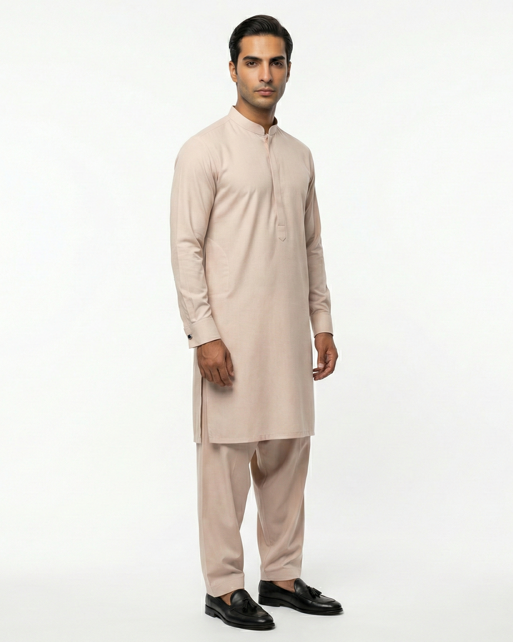 Man wearing a beige kurta with pants against a white background