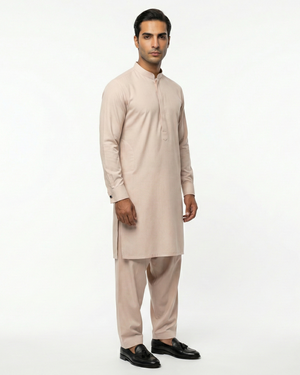 Man wearing a beige kurta with pants on a white background