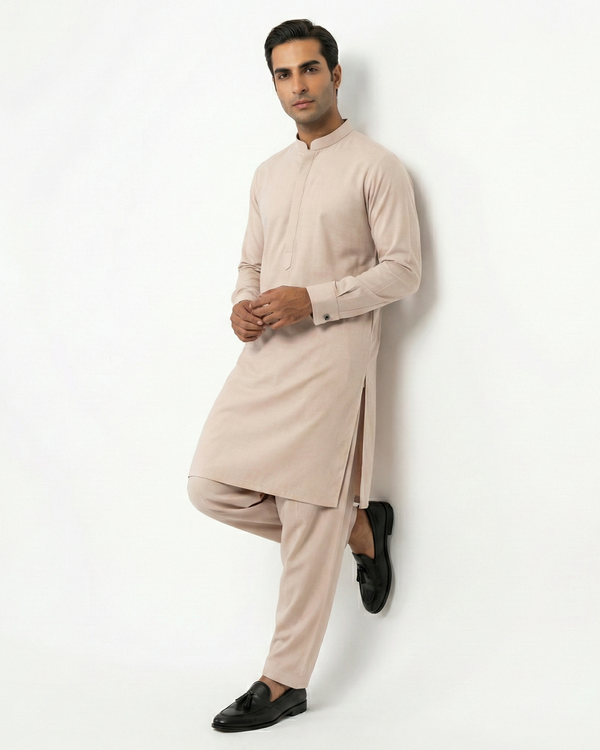 Man wearing a beige kurta with pants against a white background