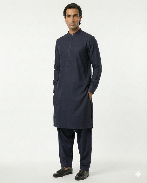 Man wearing a navy kurta with pants on a white background